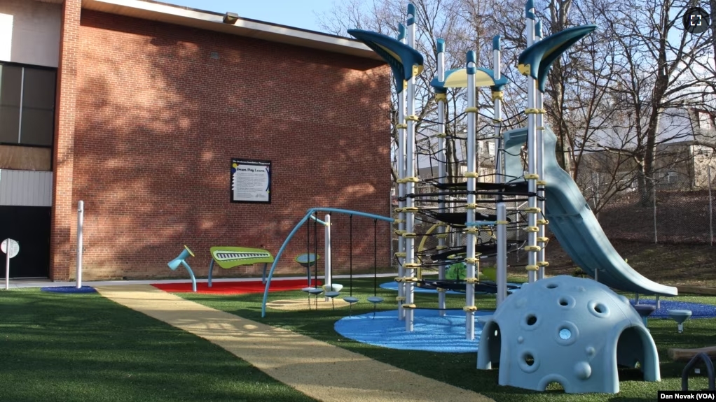 The inclusive playground at Transformation Academy in Baltimore, Maryland. In the background is a xylophone and drums where children can play music. (Dan Novak/VOA)