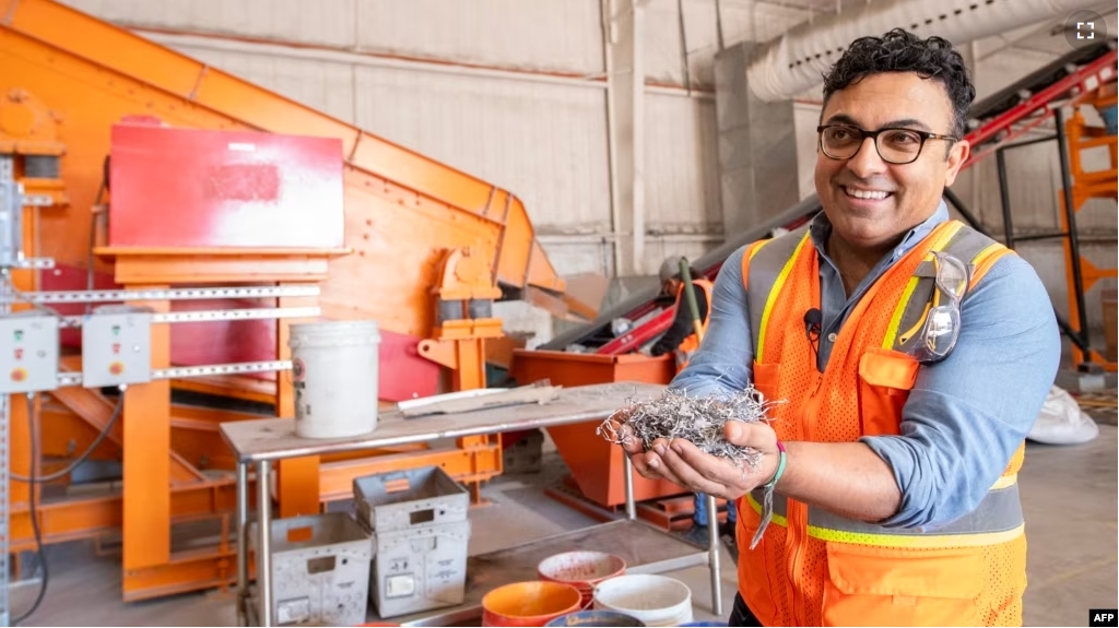 We Recycle Solar Chief Executive Office, Adam Saghei shows metals removed from solar panels to be recycled t the We Recycle Solar plant in Yuma, Arizona, Dec. 6, 2023. (Photo by VALERIE MACON / AFP)