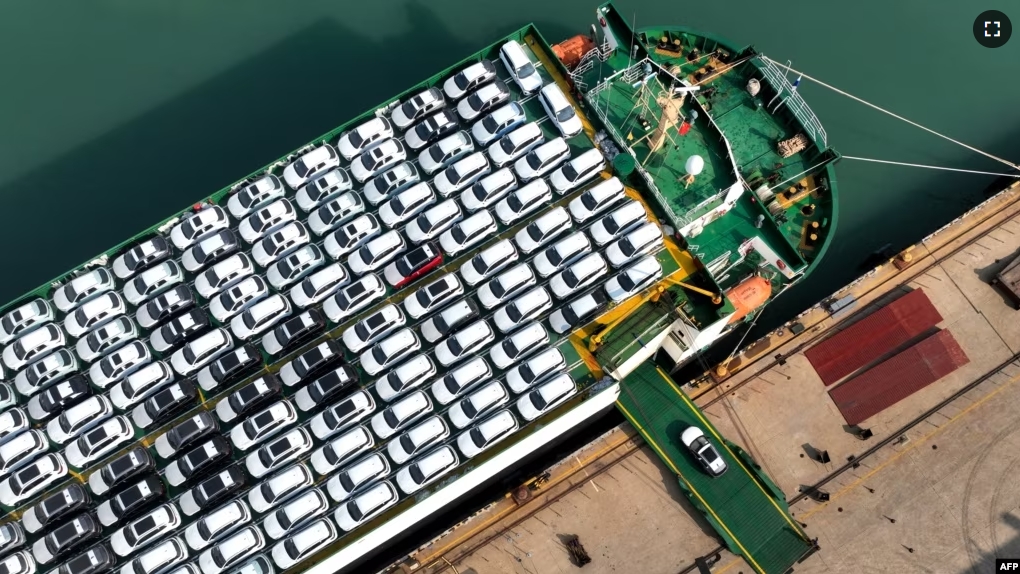 This photo taken on December 5, 2023 shows cars being loaded onto a ship for export at the port in Lianyungang, in Chinas eastern Jiangsu province. (Photo by AFP)