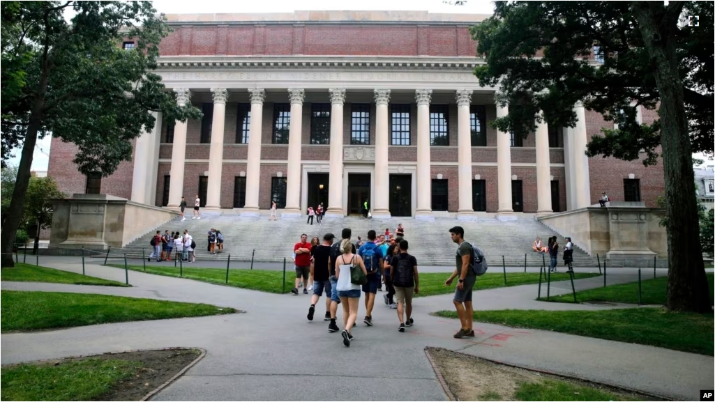 FILE - In this Aug. 13, 2019 file photo, students walk near the Widener Library in Harvard Yard at Harvard University in Cambridge, Mass. (AP Photo/Charles Krupa)