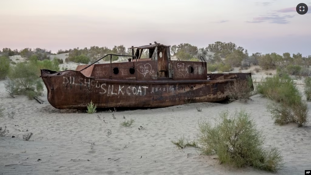 A rusting ship sits in a dried-up area of the Aral Sea in Muynak, Uzbekistan, Sunday, June 25, 2023. (AP Photo/Ebrahim Noroozi)