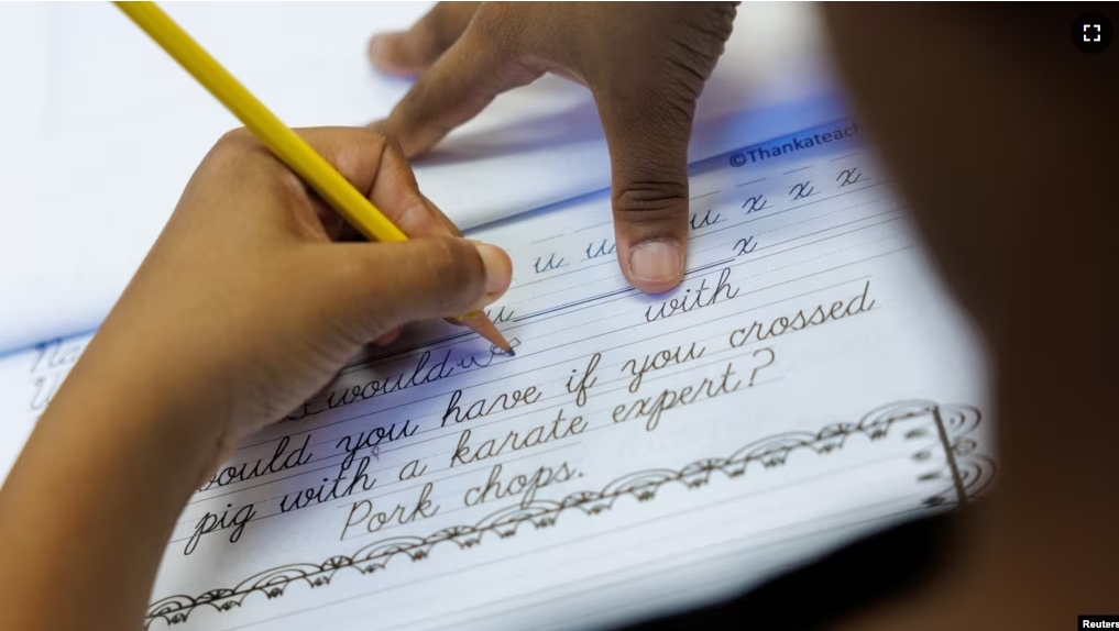 A student at Orangethorpe Elementary School practices writing cursive as California grade school students are being required to learn cursive handwriting this year, in Fullerton, California, U.S. January 23, 2024. (REUTERS/Mike Blake)