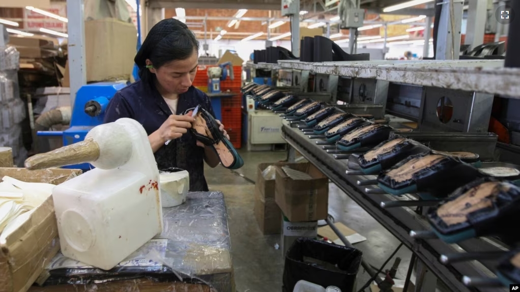 FILE - A woman works in a shoe maquiladora or factory in Leon, Mexico, Feb. 7, 2023. For the first time in more than twenty years, Mexico overtook China as America's top supplier of goods. (AP Photo/Mario Armas, File)