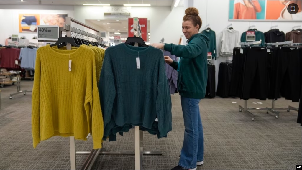 An employee straightens displays at a Kohl's store in Clifton, N.J., Friday, Jan. 26, 2024. (AP Photo/Seth Wenig)