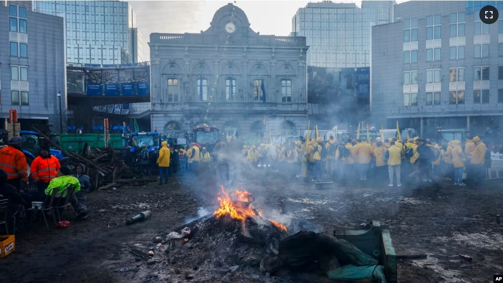 Farmers gather outside the European Parliament for a protest as European leaders meet for an EU summit in Brussels, Thursday, Feb. 1, 2024. (AP Photo/Thomas Padilla)