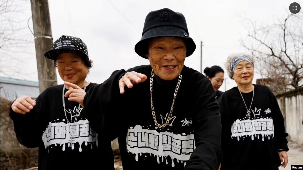 Park Jeom-sun, 81, the leader of the granny rap group "Suni and Seven Princesses", along with members Hong Sun-yeon, 79, and Jeong Du-i, 90, raps on the street in Chilgok, South Korea, February 6, 2024. (REUTERS/Kim Soo-hyeon)