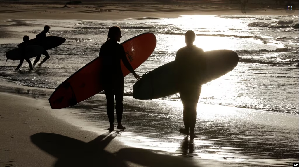 FILE - Surfers prepare to enter the water at Bondi beach near Sydney, Australia on April 28, 2020. (AP Photo/Rick Rycroft)