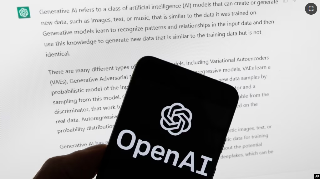 FILE - The OpenAI logo is seen on a mobile phone in front of a computer screen displaying output from ChatGPT, on March 21, 2023, in Boston. (AP Photo/Michael Dwyer, File)