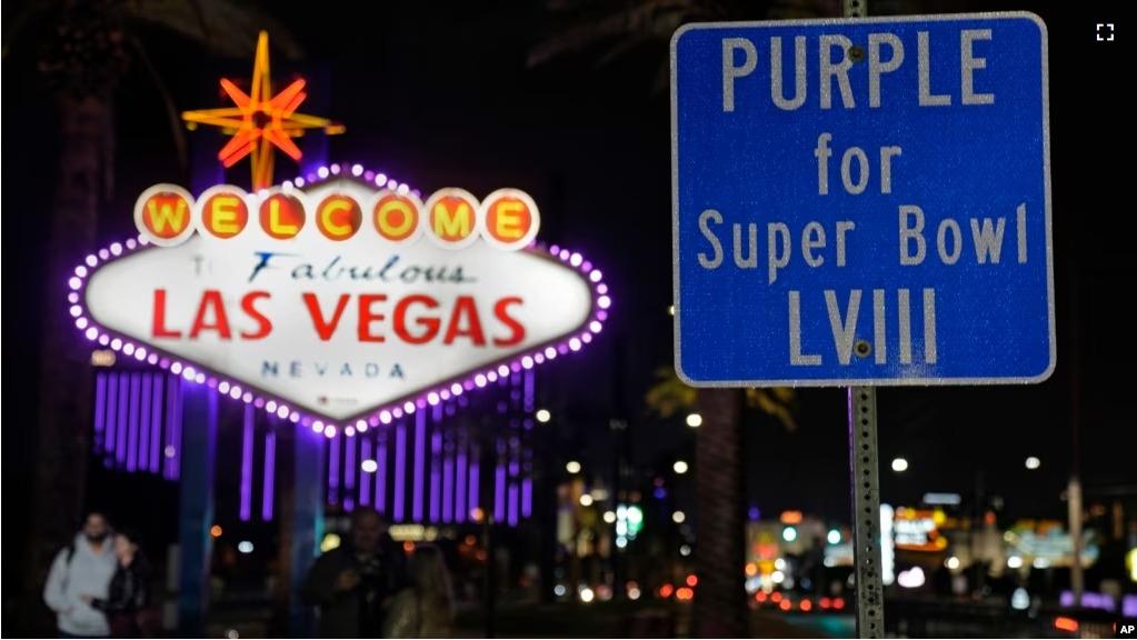 The Welcome to Las Vegas is outlined in purple for the Super Bowl, Feb. 6, 2024, in Las Vegas. On Sunday, the city will host the Kansas City Chiefs and the San Francisco 49ers in Super Bowl 58. (AP Photo/Charlie Riedel)