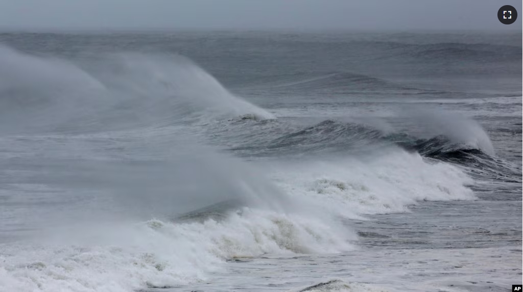 FILE - Wind blown waves from Hurricane Florence hit the beach in Emerald Isle N.C., Thursday, Sept. 13, 2018. (AP Photo/Tom Copeland)