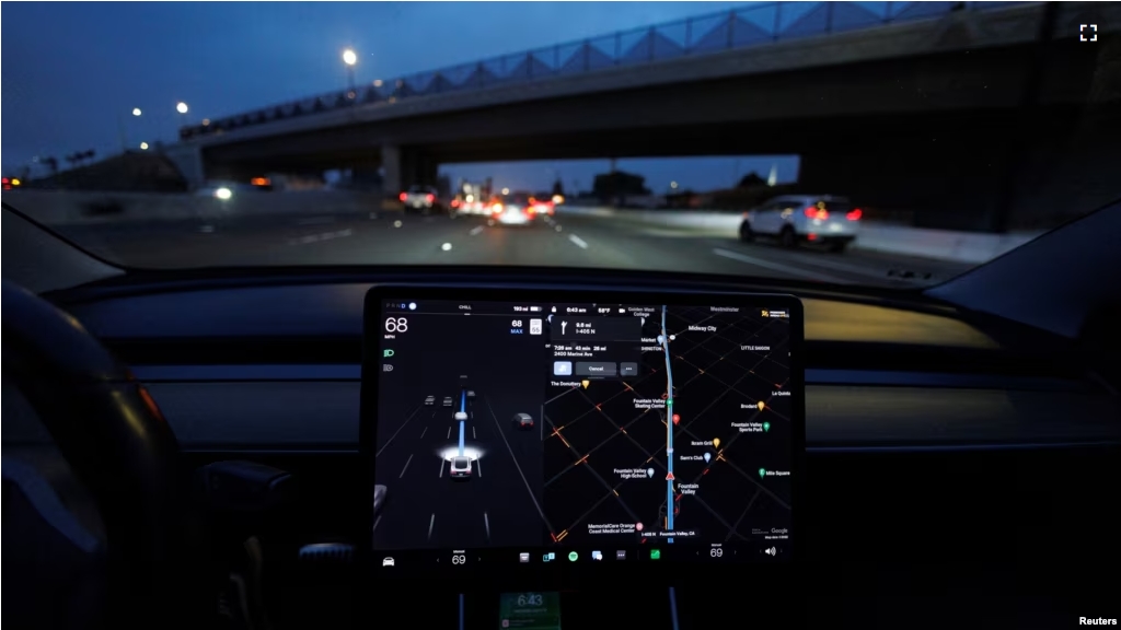 FILE - A Tesla Model 3 vehicle drives on autopilot along the 405 highway in Westminster, California, U.S., March 16, 2022. (REUTERS/Mike Blake)