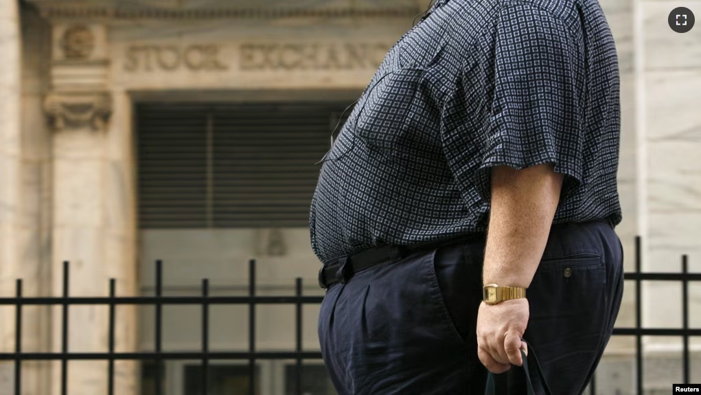 A man walks past the New York Stock Exchange after the close of trading hours in New York City on August 17, 2009. (REUTERS/Lucas Jackson)