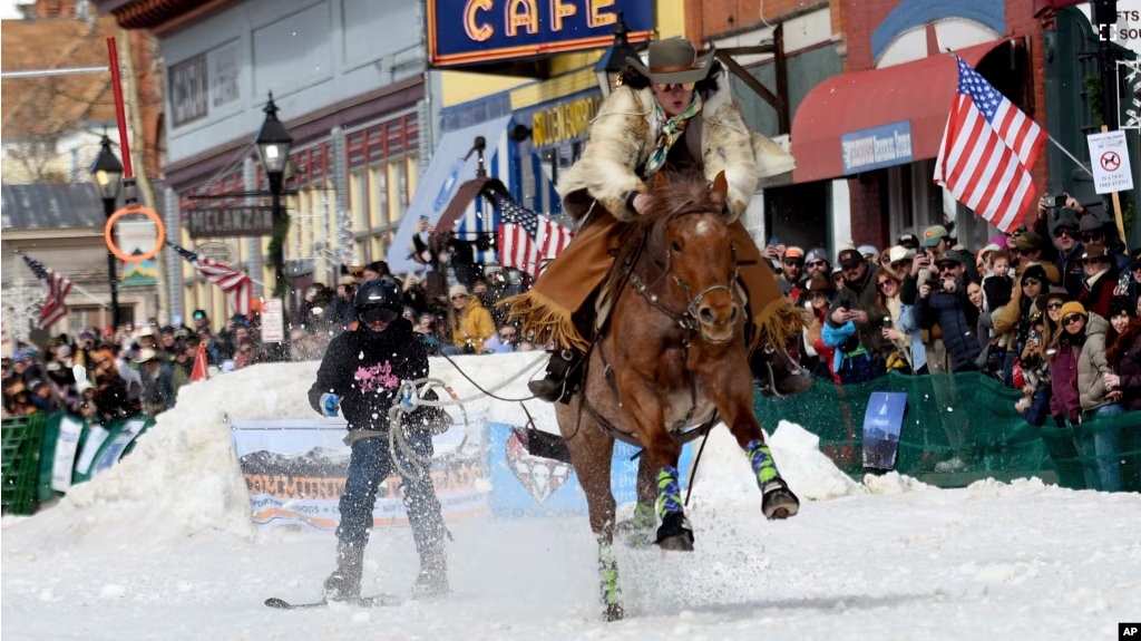 A skijoring team competes in Leadville, Colo., on Saturday, March 2, 2024. Skijoring draws its name from the Norwegian word skikjoring, meaning "ski driving." (AP Photo/Thomas Peipert)