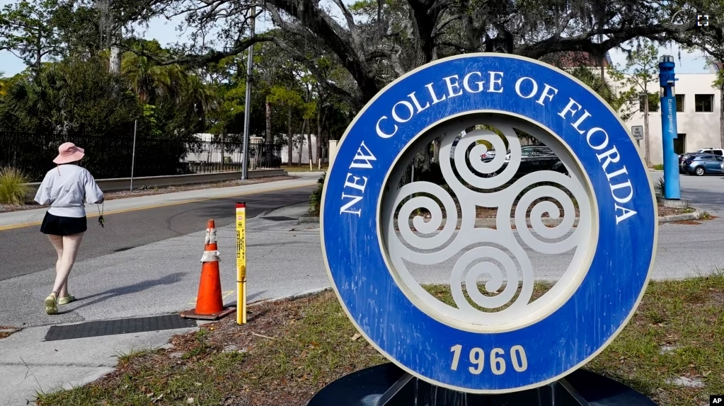 FILE - A student makes her way past the sign at New College of Florida, Jan. 20, 2023, in Sarasota, Fla. (AP Photo/Chris O'Meara, File)