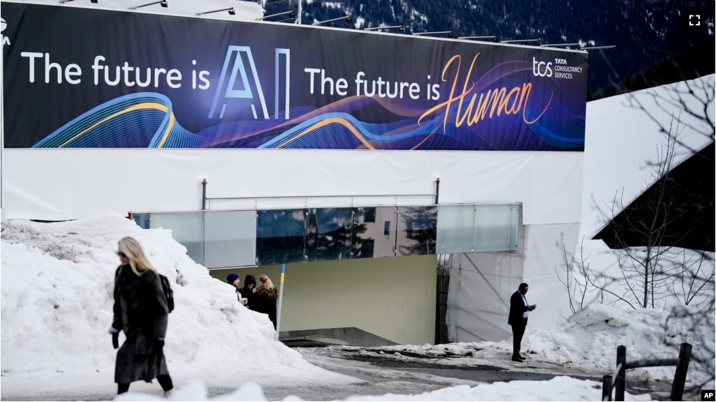 FILE - An advertising banner with a slogan about AI is fixed at a building at the Davos Promenade, alongside the World Economic Forum in Davos, Switzerland, Jan. 18, 2024. (AP Photo/Markus Schreiber, File)