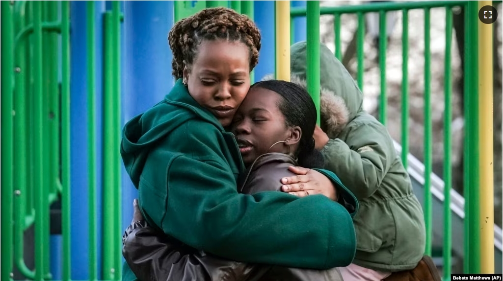 Derry Oliver, 17, right, hugs her mother, also Derry Oliver, during a visit to a playground near home, Friday, Feb. 9, 2024, in New York. (AP Photo/Bebeto Matthews)