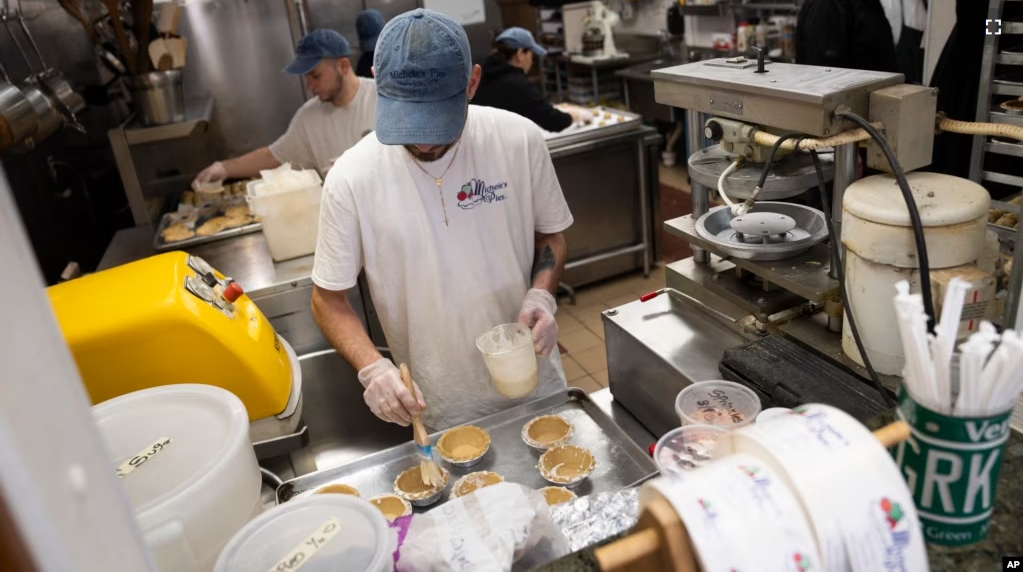 Employees are busy making pies at Michele's Pies in Norwalk, Connecticut for Pi Day on March 14 or 3/14, the first three digits of a mathematical constant with many practical uses. (AP Photo/John Minchillo)