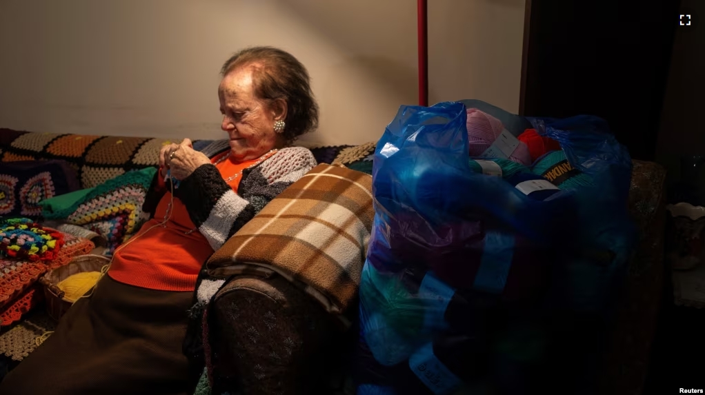 Ioanna Matsouka, 93, knits scarves in her house in Athens, Greece, March 6, 2024. (REUTERS/Karolina Tagaris)