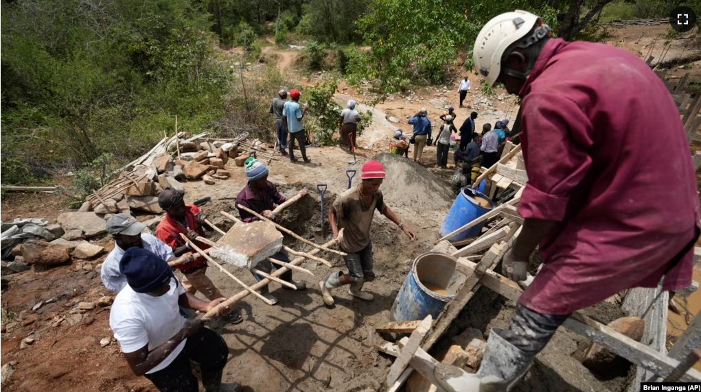 Members of Kyemoo Power, a self-help group, construct a sand dam in Makueni County, Kenya on Thursday, Feb. 29, 2024. Building sand dams helps minimize water loss through evaporation and recharges groundwater. (AP Photo/Brian Inganga)