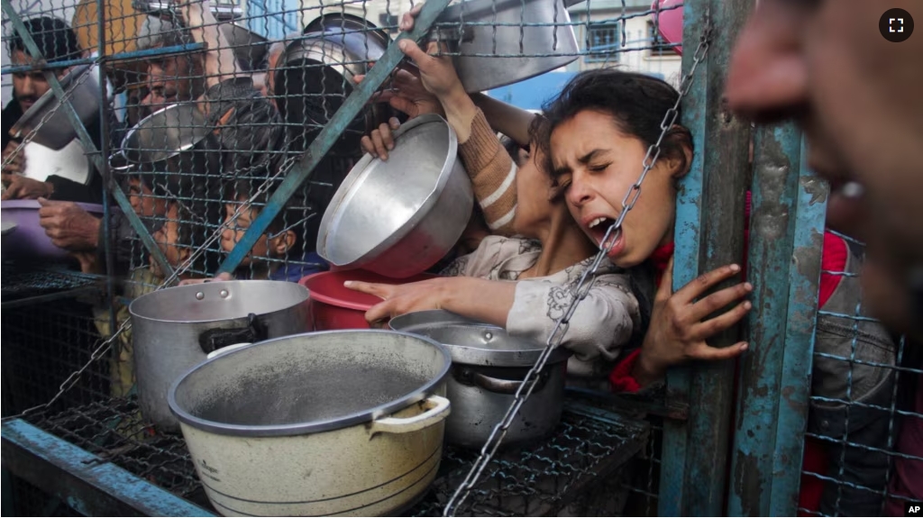 FILE - Palestinians line up to receive free meals at Jabaliya refugee camp in the Gaza Strip on Monday, March 18, 2024. (AP Photo/Mahmoud Essa)