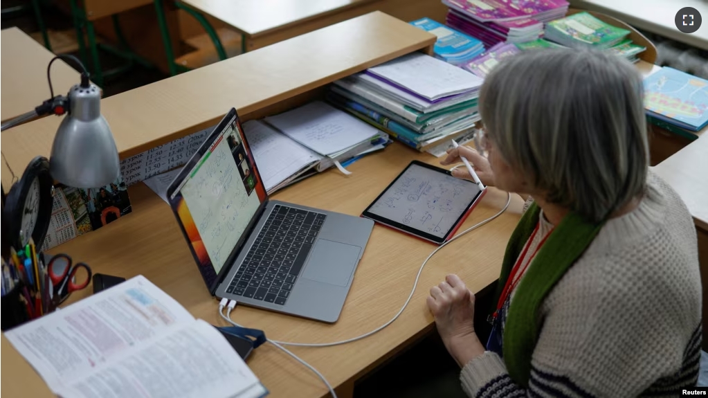 FILE - Teacher conducts an online chemistry lesson in a classroom at a school, amid Russia's attack on Ukraine, in Kyiv, Ukraine, Dec. 2, 2022. ( REUTERS/Valentyn Ogirenko)