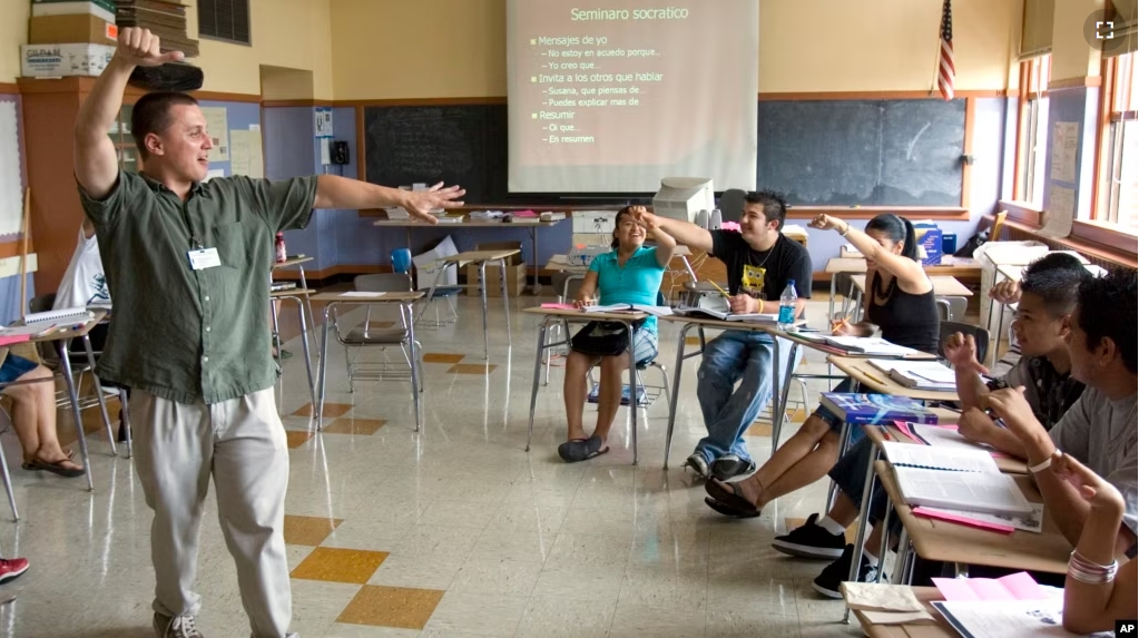 FILE - ESL (English-as-a-second-language) teacher Xavier Chavez, standing, teaches a summer history class at Benson High School in Portland, Ore.,Wednesday, Aug. 6, 2008. (AP Photo/Don Ryan)