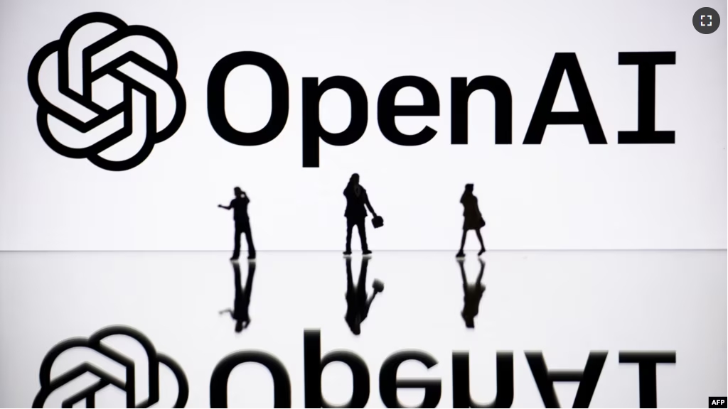 FILE - This illustration photograph taken on October 30, 2023, in Mulhouse, eastern France, shows figurines next to a screen displaying a logo of OpenAI. (Photo by SEBASTIEN BOZON / AFP)