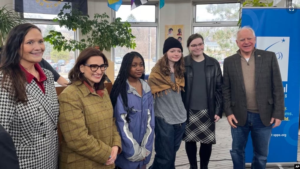 Bloomington Jefferson senior Shae Ross, fourth from left, joins Governor Tim Walz, right, at an event promoting proposed legislation to prevent books bans at Como Park High School in St. Paul, Minnesota on March 21, 2024. (Chris Williams/Education Minnesota via AP)