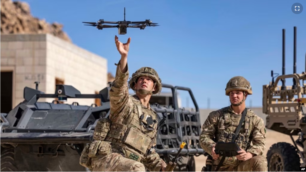 FILE - In this photo from the Defense Visual Information Distribution Service, British soldiers launch a drone during Project Convergence exercises at Fort Irwin, Calif., on Nov. 4, 2022. (DVIDS via AP)