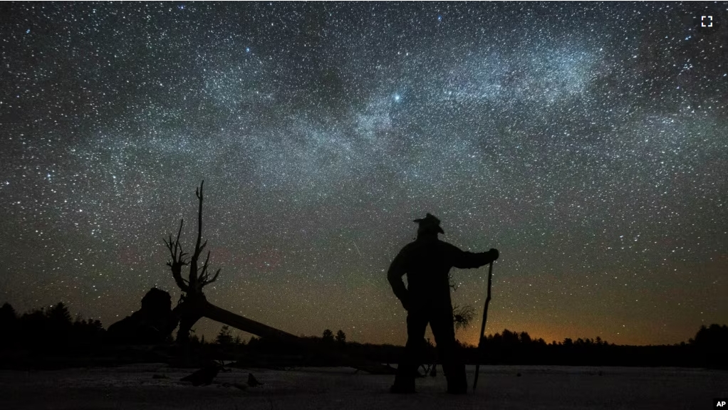 FILE - In this file photo, Dave Cooke observes the Milky Way in Ontario, Canada, early Sunday, March 21, 2021. (Fred Thornhill/The Canadian Press via AP)