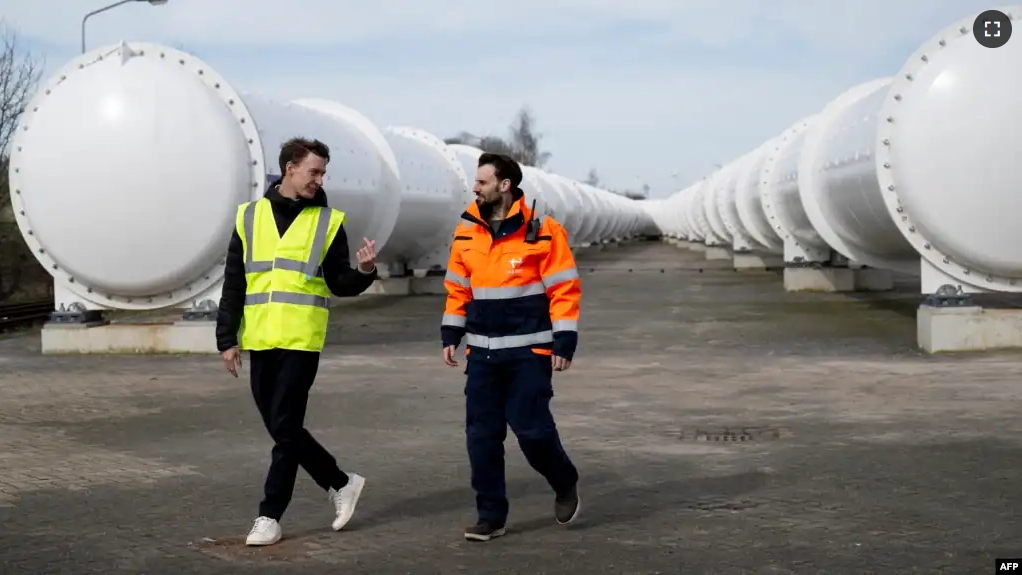 EHC Director Sascha Lamme (L) and Tech and Engineering Director of EHC Marinus Van Der Meis (R) walk at the European Hyperloop Center (EHC), in Veendam on March 26, 2024. (Photo by Nick Gammon / AFP)