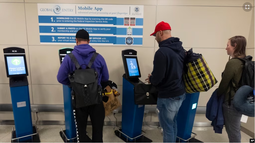 International travelers stop and use the portal to get their initial processing and instructions on their next procedure, in the port of entry at Washington Dulles International Airport in Chantilly, Va. Monday, April 1, 2024. (AP Photo/Manuel Balce Ceneta)