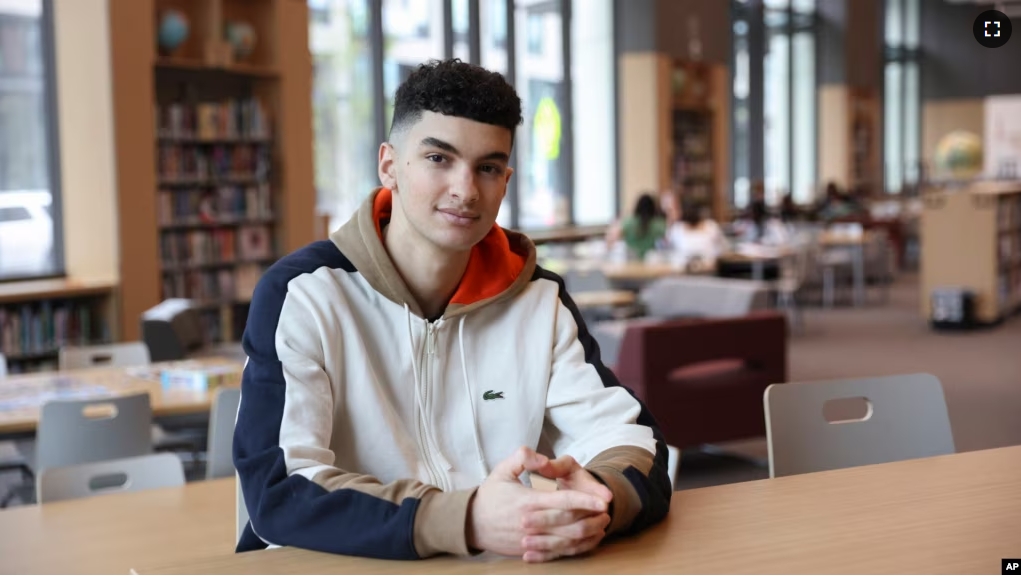 Max Decker, a senior at Lincoln High School, sits for a portrait in the school library where he often worked on writing his college essays, in Portland, Ore., Wednesday, March 20, 2024. (AP Photo/Amanda Loman)