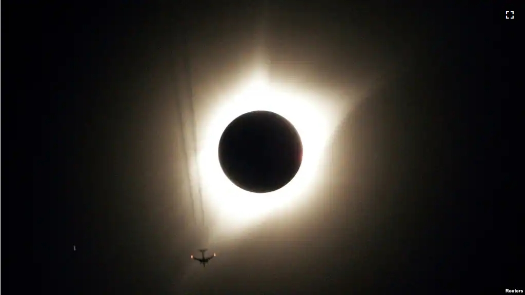 This file photo shows a partial solar eclipse happening as jet plane flies by the eclipse in Guernsey, Wyoming U.S., August 21, 2017. (REUTERS/Rick Wilking)