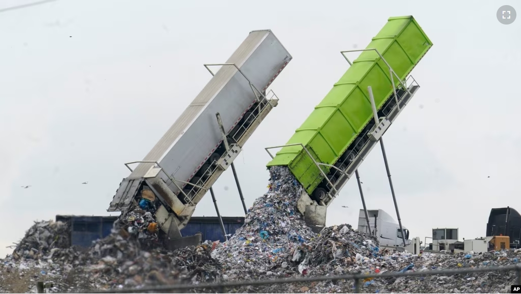 In this file photo, garbage is loaded into a landfill in Lenox Township, Mich., July 28, 2022. (AP Photo/Paul Sancya, File)