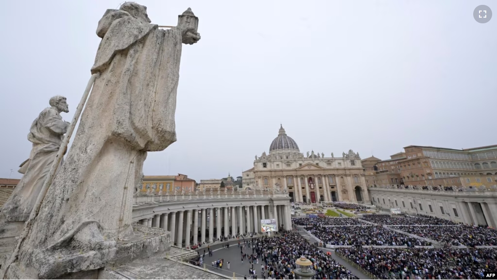 FILE - A general view shows the crowd during the Easter Mass as part of the Holy Week celebrations, at St Peter's Square in the Vatican on March 31, 2024. (Photo by Tiziana FABI / AFP)