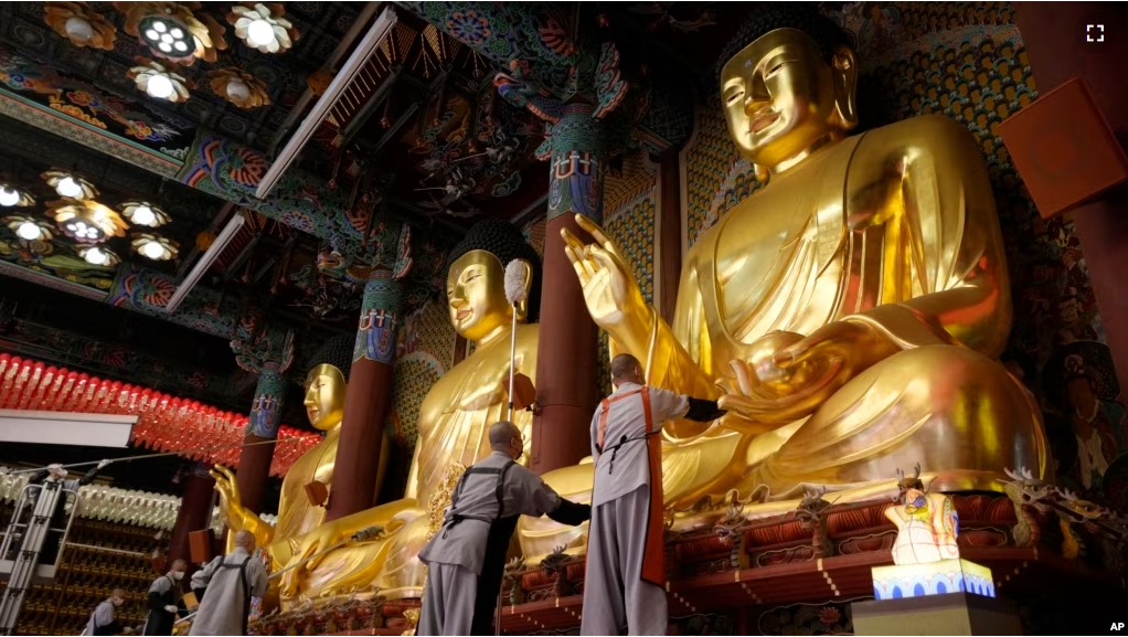 Buddhists monks clean Buddha statues ahead of the upcoming birthday of Buddha on May 15, at the Jogye temple in Seoul, South Korea, Tuesday, May 7, 2024. (AP Photo/Ahn Young-joon)