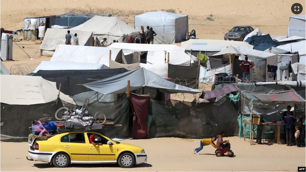 Displaced Palestinians transport their belonging atop a car as they flee to a safer area in Rafah in the southern Gaza Strip on May 9, 2024. (Photo by AFP)