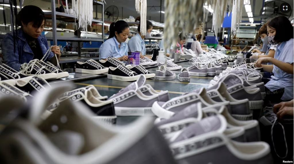 FILE - Employees work at a shoe factory for export in Hanoi, Vietnam December 29, 2020. (REUTERS/Kham/File Photo)