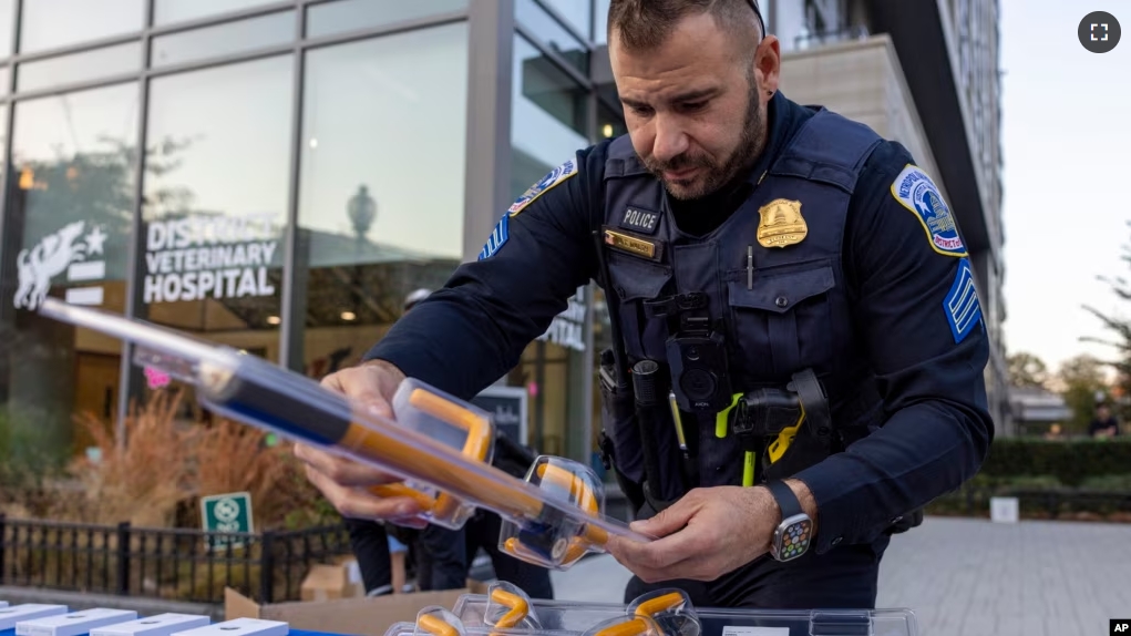 FILE - Metropolitan Police Department Sgt. Anthony Walsh sets out steering wheel locks at an anti-crime event in Washington on Nov. 7, 2023. A physical lock that attaches to the steering wheel can act as a visible deterrent to car thieves. (AP Photo/Amanda Andrade-Rhoades, File)