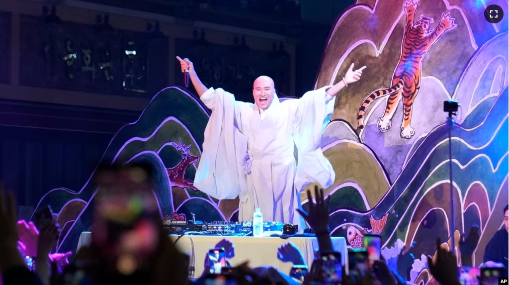 NewJeansNim, a comedian and a DJ, whose real name is Youn Sung Ho, performs at an annual lantern-lighting festival dressed up as a monk, in Seoul, South Korea on May 12, 2024. (AP Photo/Juwon Park)