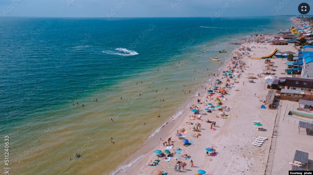 FILE - People on vacation enjoy the beach at Kyrylivka on the Sea of Azov in southern Ukraine. (Adobe Stock Photo by Denis Chubchenko)