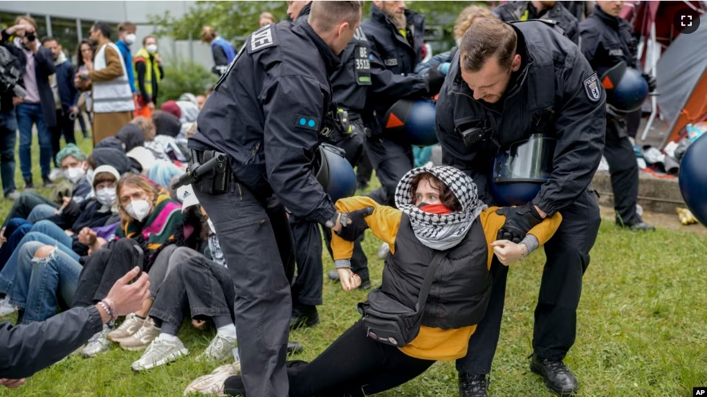 Police remove a protester from the 'Freie Universität Berlin' in Berlin, Germany, Tuesday, May 7, 2024. Pro-Palestinian activists occupied a courtyard of the Free University in Berlin on Tuesday. (AP Photo/Markus Schreiber)