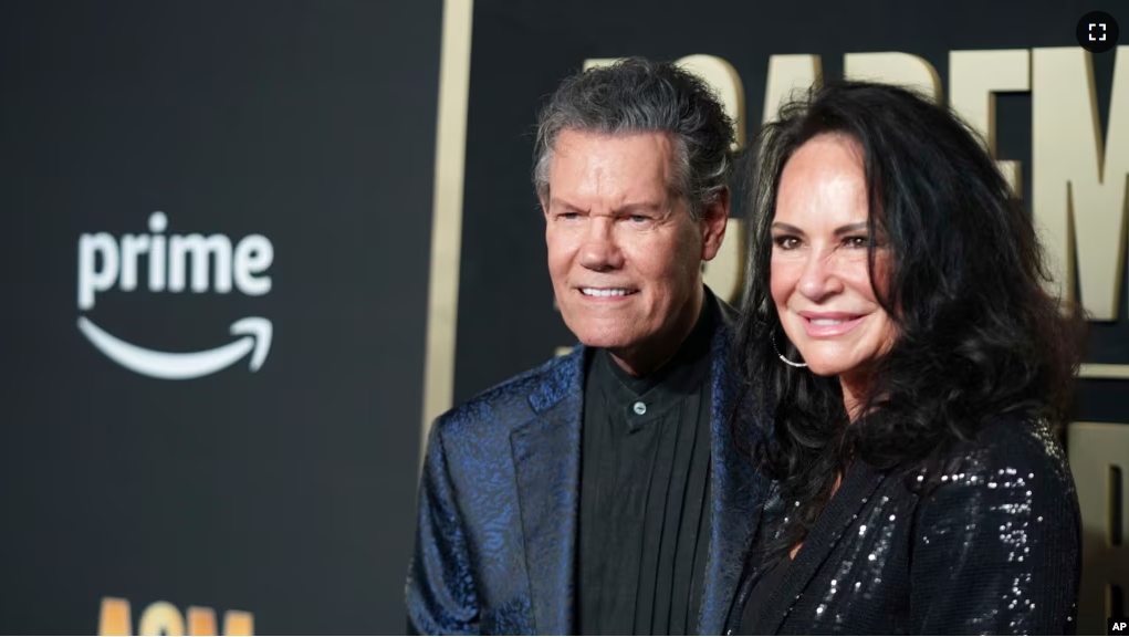 FILE - Randy Travis, left, and his wife, Mary, arrive at the 58th annual Academy of Country Music Awards on Thursday, May 11, 2023, at the Ford Center in Frisco, Texas. (AP Photo/Jeffrey McWhorter)