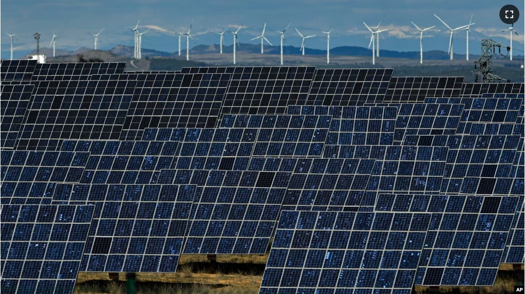 FILE - Solar panels and windmills work near the small town of Milagro, Navarra Province, northern Spain, Feb. 24, 2023. (AP Photo/Alvaro Barrientos, File)