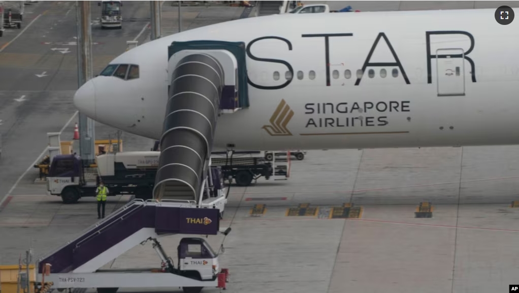 The Boeing 777-300ER aircraft of Singapore Airlines is parked at Suvarnabhumi International Airport, near Bangkok, Thailand, May 22, 2024. The plane dropped around 1,800 meters in about three minutes after hitting severe turbulence over the Indian Ocean. (AP Photo/Sakchai Lalit)