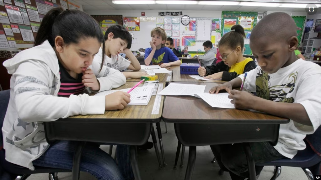 FILE - Third-grade students do school work during class at Hanby Elementary School, Feb. 15, 2011, in Mesquite, Texas. (AP Photo/LM Otero, File)