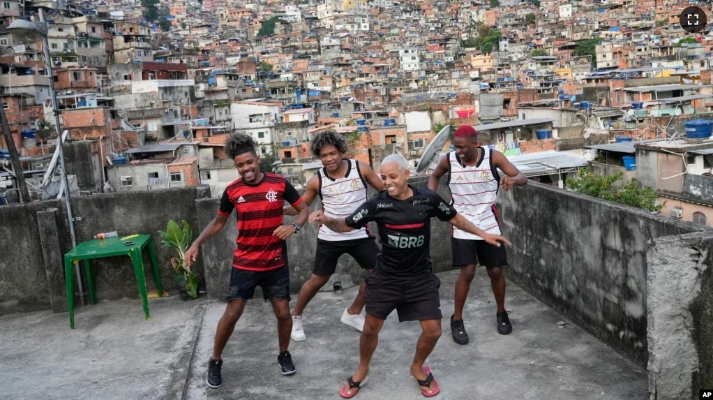 Youth perform a street dance style known as passinho for their social media accounts, in the Rocinha favela of Rio de Janeiro, Brazil, Wednesday, April 17, 2024. (AP Photo/Silvia Izquierdo)