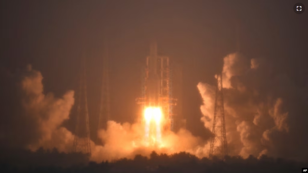 In this photo provided by China's Xinhua News Agency, a Long March-5 rocket, carrying the Chang'e-6 spacecraft, blasts off from its launchpad at the Wenchang Space Launch Site in Wenchang, Friday, May 3, 2024. (Guo Cheng/Xinhua via AP)