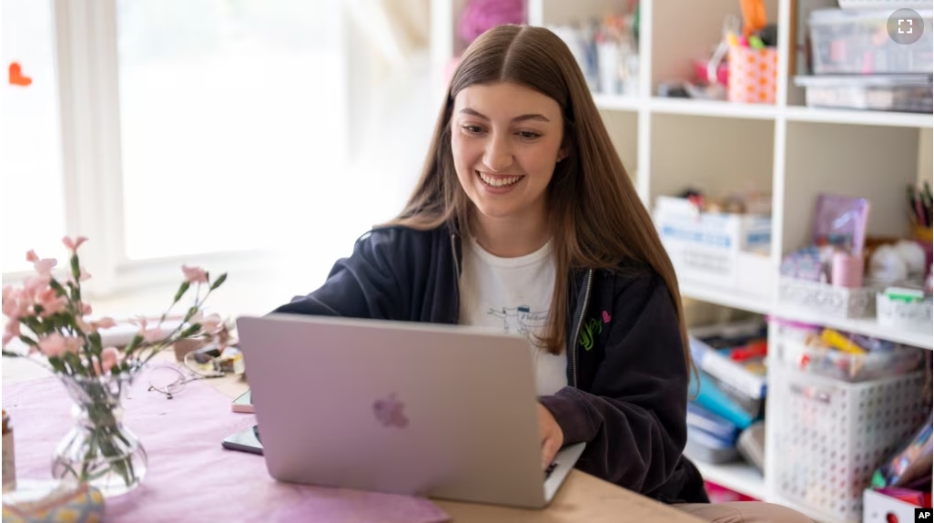 Amea Wadsworth works on her computer at her home, Friday, April 19, 2024, in San Diego. (AP Photo/Gregory Bull)